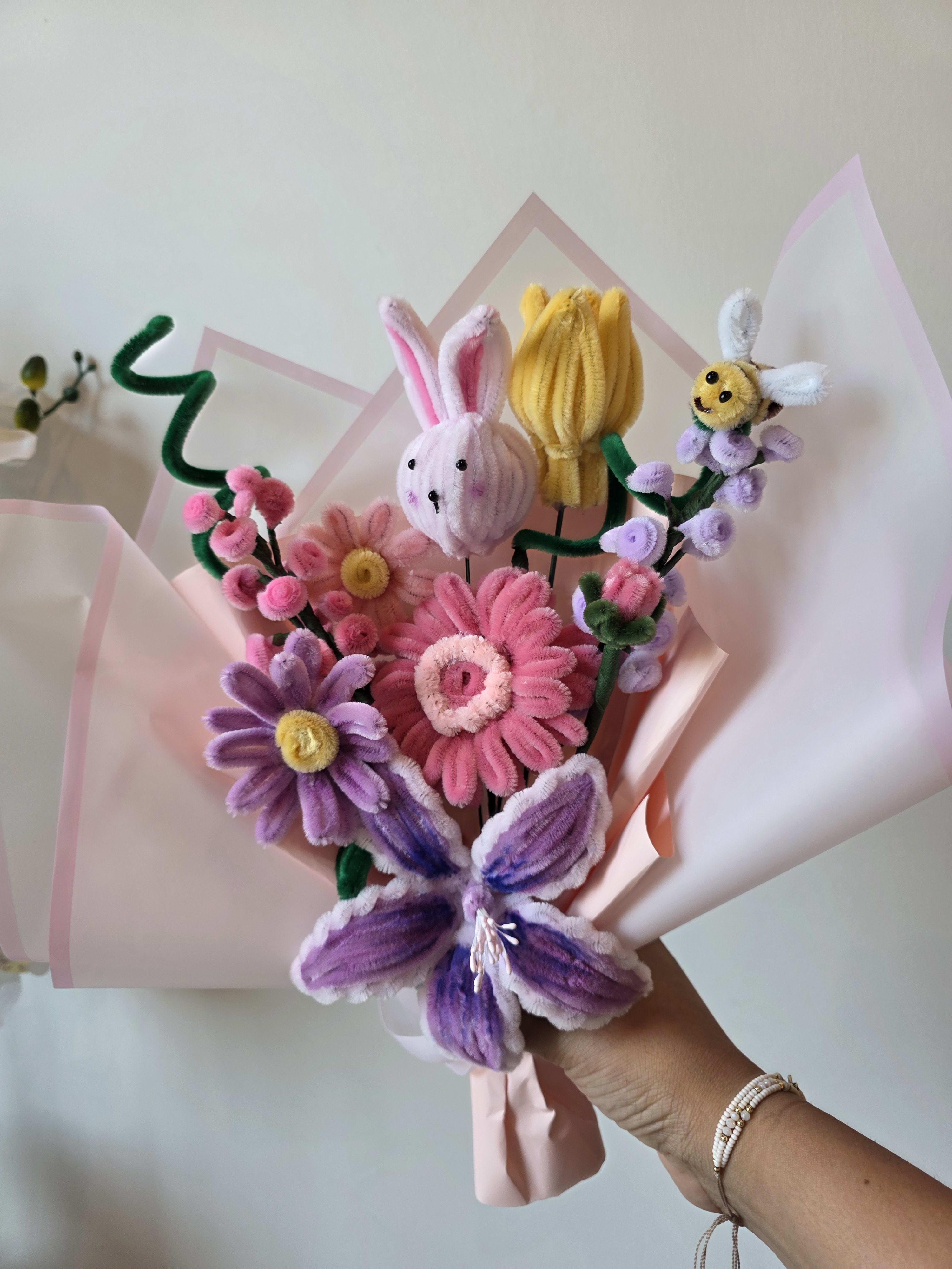 Pastel Meadow Handcrafted Chenille Flower Bouquet being gently arranged in a glass vase