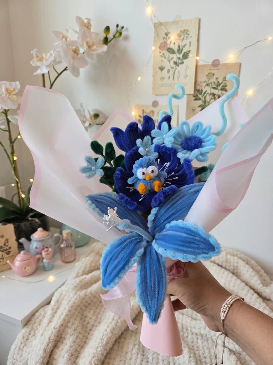 Ocean Mist Bouquet β Artisan ocean blue chenille flower bouquet crowned with an adorable penguin keepsake topper. (detail angle)