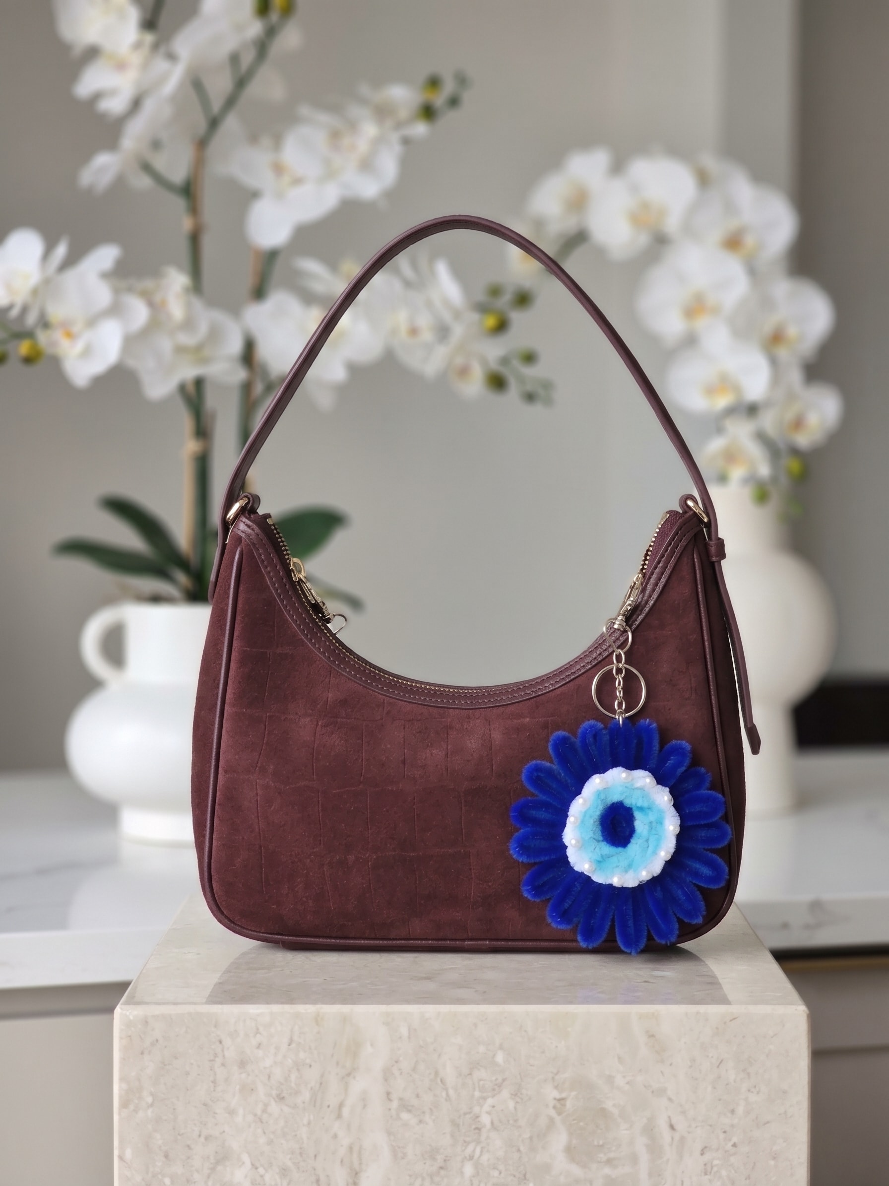 Blue Evil Eye Keychain β A handmade floral keychain featuring a bold royal blue flower design with an evil eye-inspired center and delicate pearl-style detailing. Perfect for keys, handbags, backpacks, and gifting. (detail angle)
