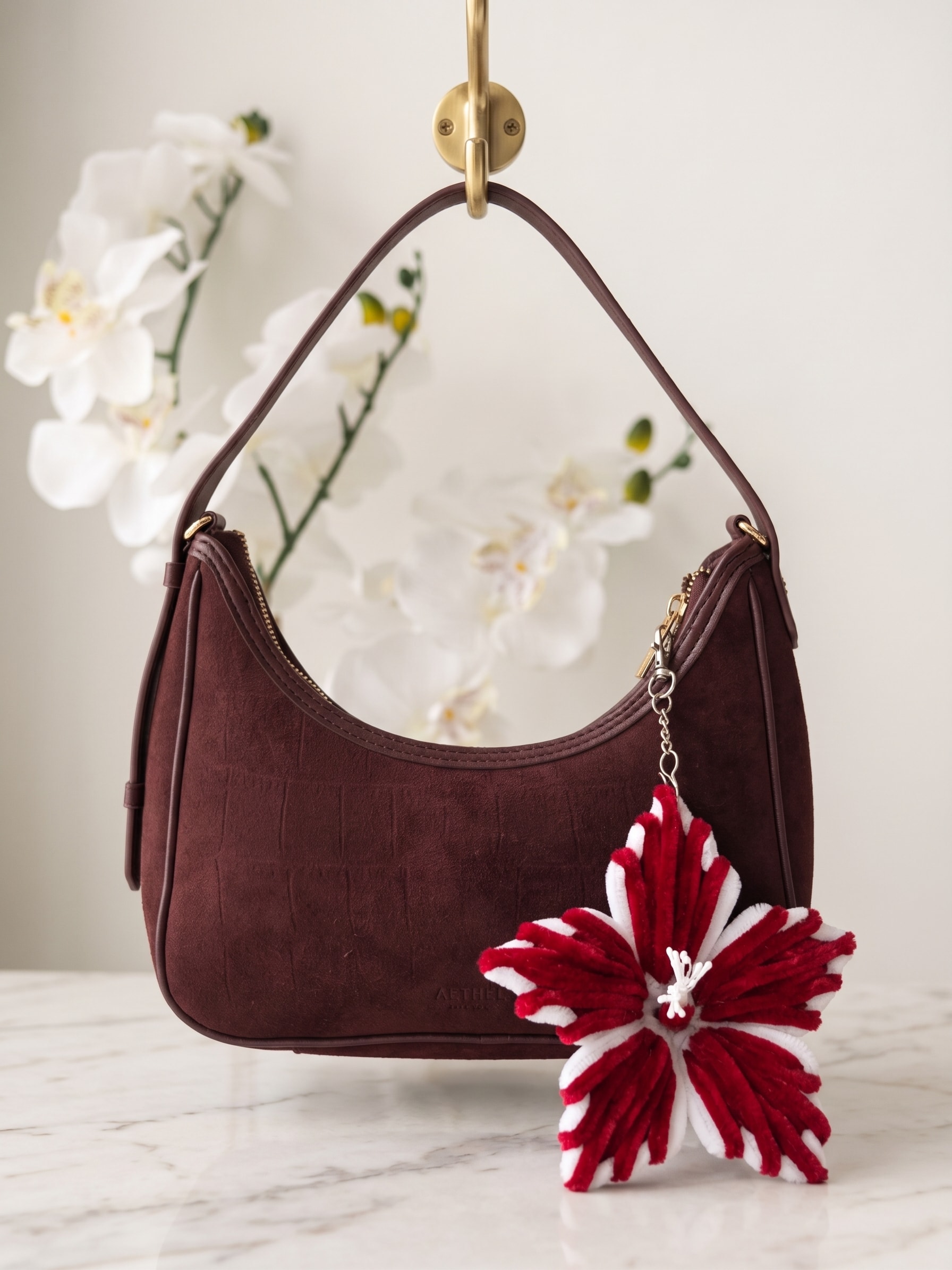 Crimson Hibiscus Keychain β A bold handmade floral keychain inspired by a hibiscus bloom, featuring layered red and white petals with a delicate white center. Perfect for handbags, backpacks, purses, keys, and gifting. (detail angle)