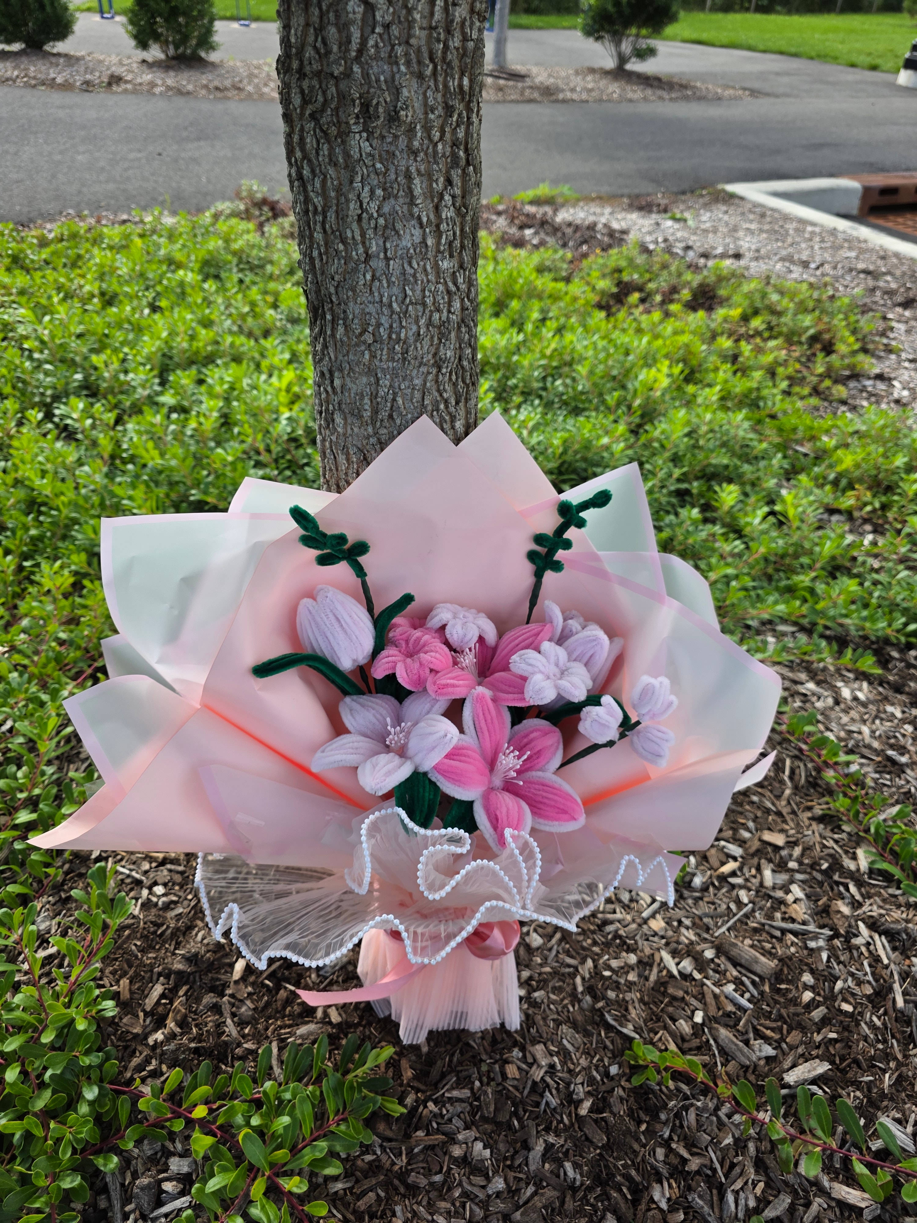Joyful Blossom β A handcrafted pipe cleaner flower bouquet featuring soft pink and lavender lilies, delicate buds, and elegant wrapping. Perfect for birthdays, anniversaries, gifts, room dΓ©cor, and special occasions. (detail angle)