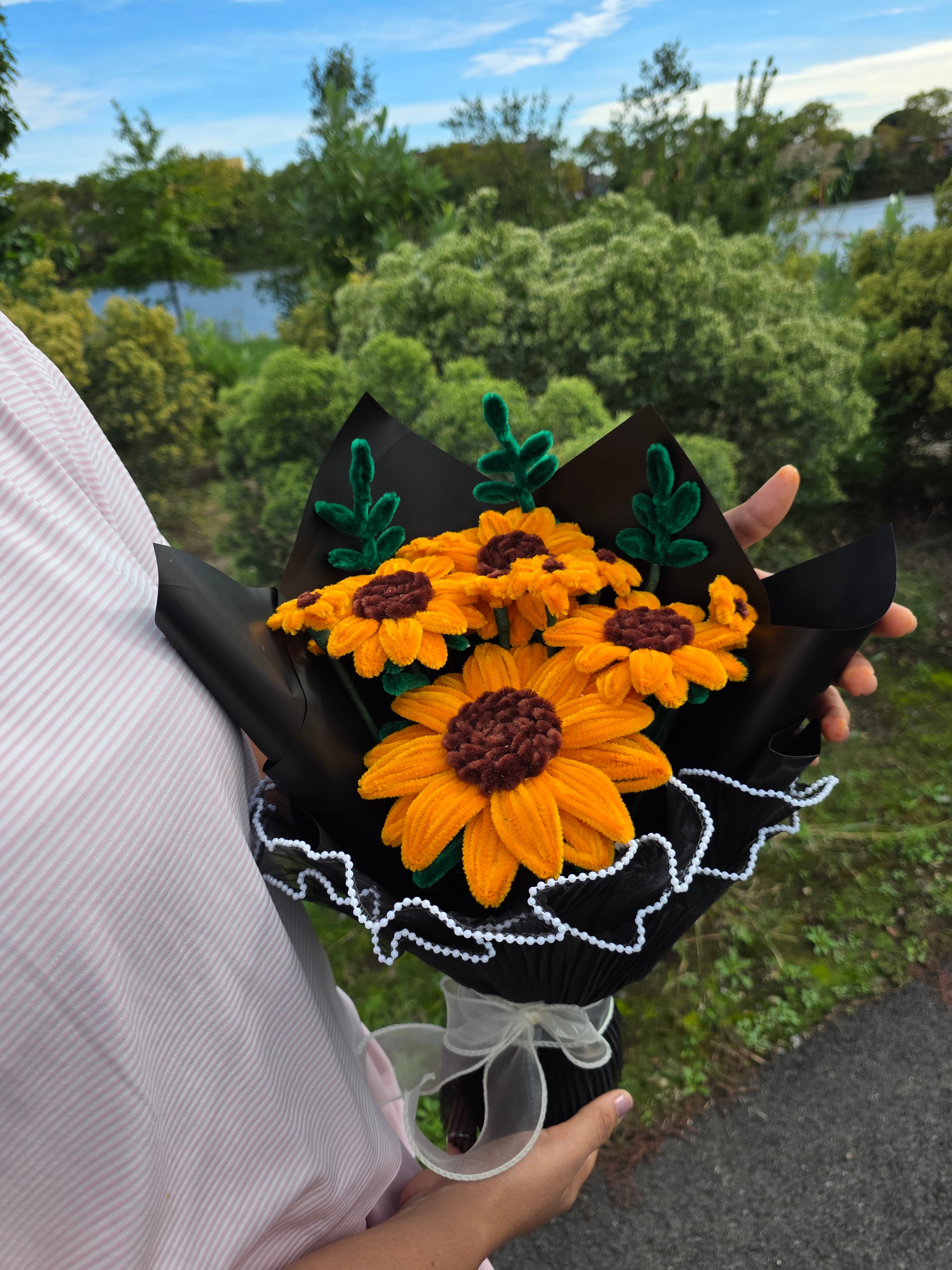 Golden Sunshine β A cheerful handmade sunflower bouquet crafted from soft pipe cleaners, featuring vibrant golden-yellow petals, rich brown centers, and green foliage. (detail angle)