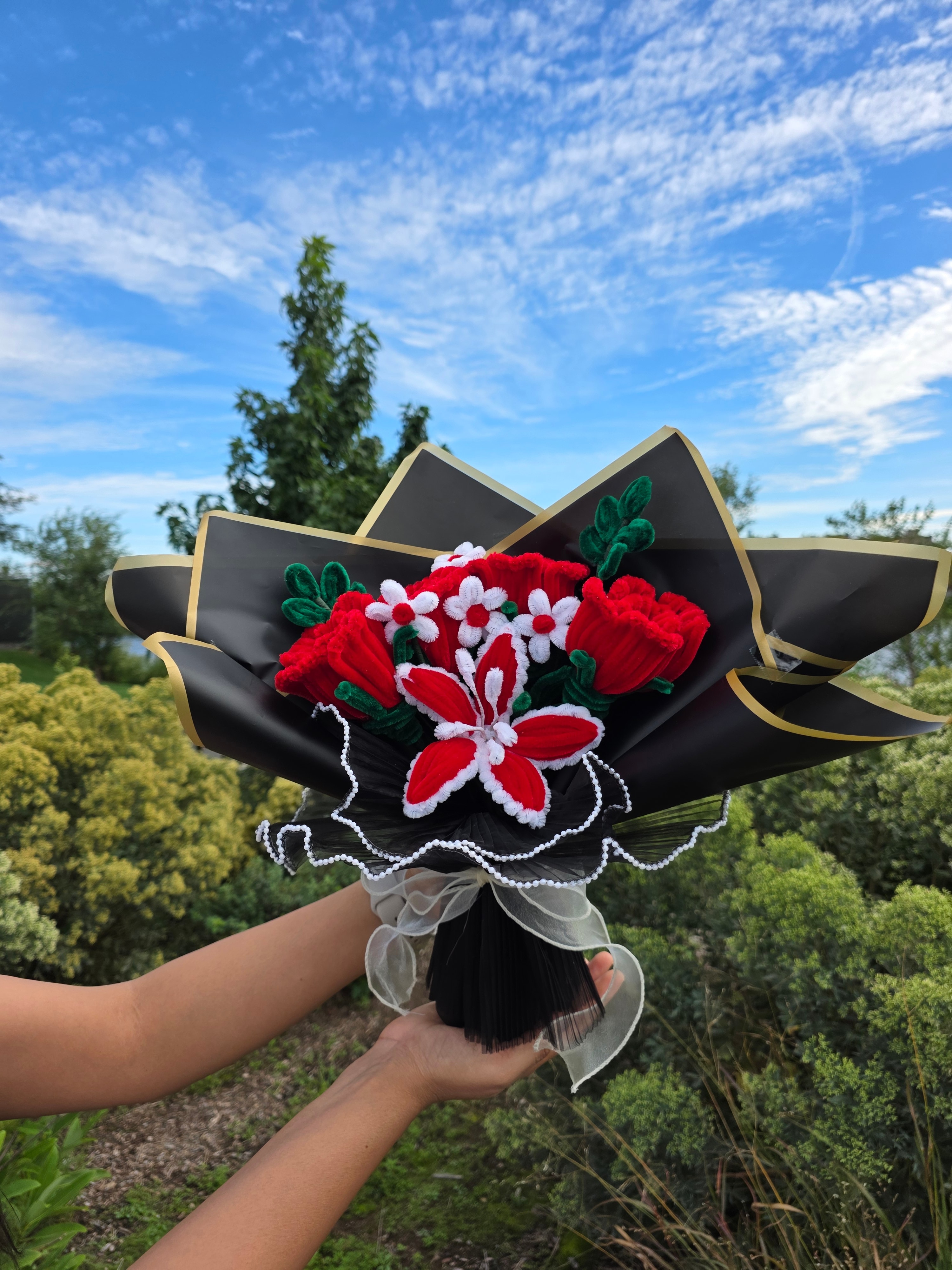 Midnight Romance β A bold handmade pipe cleaner bouquet featuring rich red roses, red-and-white lily-style blooms, delicate white accent flowers, and deep green foliage. (detail angle)
